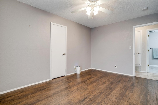 unfurnished room featuring a ceiling fan, a textured ceiling, baseboards, and wood finished floors