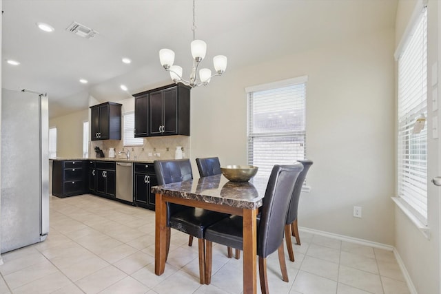 dining space featuring visible vents, baseboards, an inviting chandelier, light tile patterned flooring, and recessed lighting