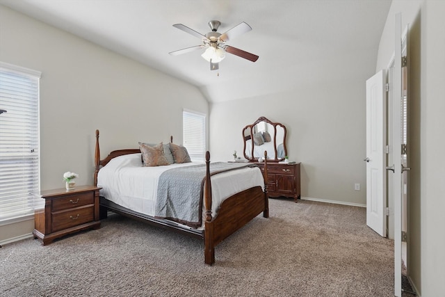 bedroom with a ceiling fan, light colored carpet, vaulted ceiling, and baseboards