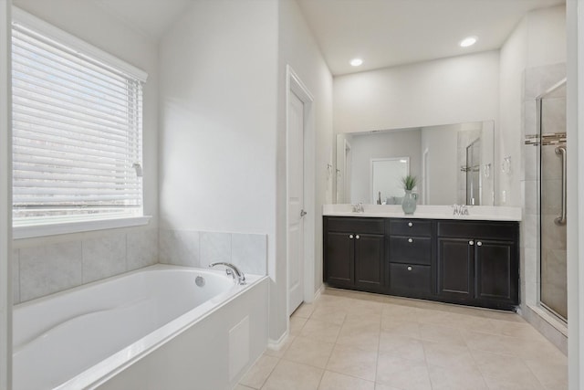 bathroom with a stall shower, a sink, a bath, and double vanity