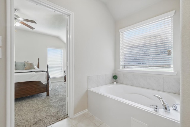 bathroom with a garden tub, vaulted ceiling, connected bathroom, ceiling fan, and tile patterned flooring