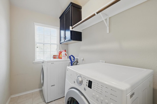 washroom with cabinet space, baseboards, light tile patterned flooring, and independent washer and dryer