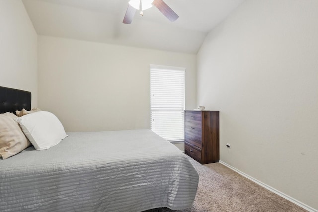 carpeted bedroom with a ceiling fan, vaulted ceiling, and baseboards