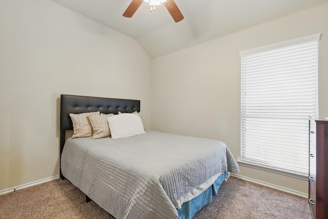 carpeted bedroom with vaulted ceiling, baseboards, and ceiling fan