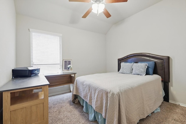 carpeted bedroom featuring a ceiling fan, vaulted ceiling, and baseboards