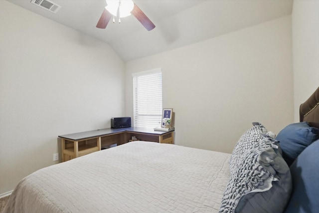 bedroom with lofted ceiling, visible vents, and a ceiling fan