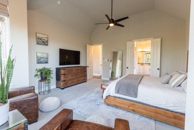 carpeted bedroom featuring a ceiling fan, baseboards, ensuite bathroom, and high vaulted ceiling