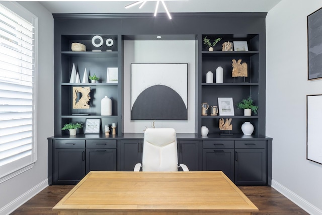 home office with dark wood finished floors, built in shelves, and baseboards