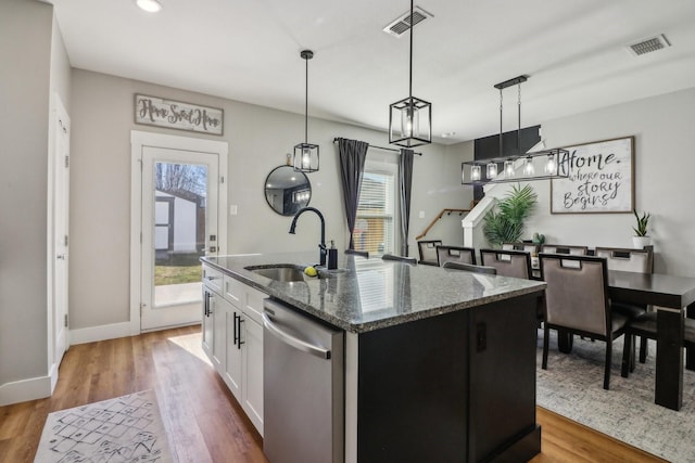 kitchen featuring dishwasher, a wealth of natural light, and visible vents