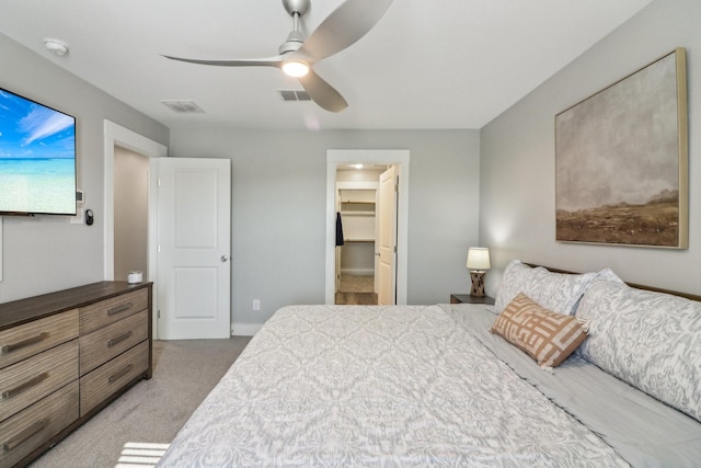 bedroom with ceiling fan, carpet floors, a spacious closet, and visible vents