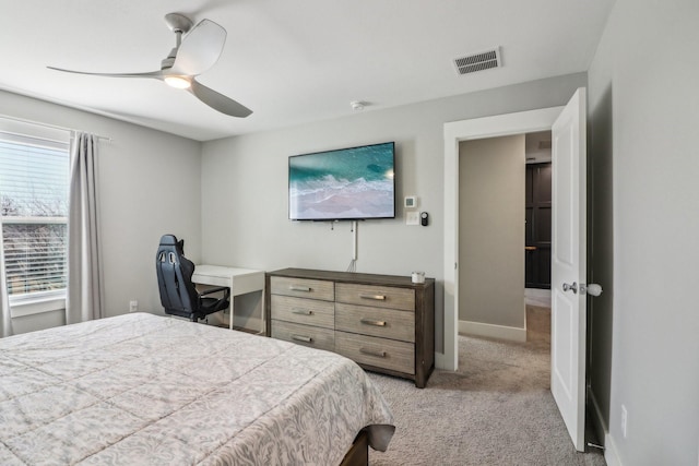 bedroom with ceiling fan, visible vents, baseboards, and light colored carpet