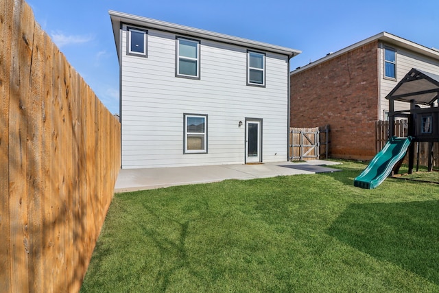 back of house featuring a patio, a lawn, a playground, and a fenced backyard