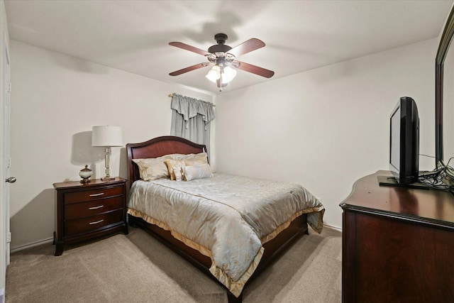 bedroom with a ceiling fan and light colored carpet