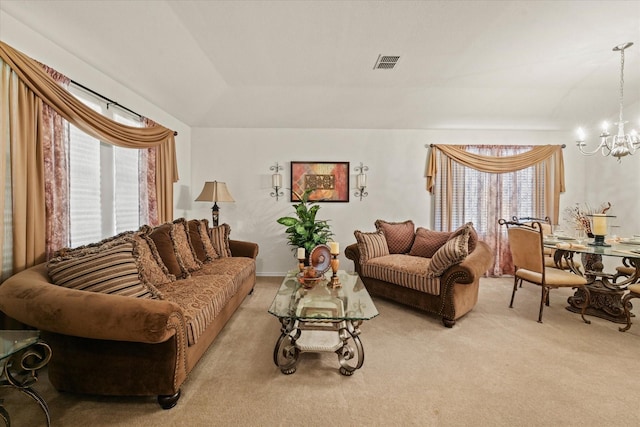 living area featuring a chandelier, light colored carpet, and visible vents