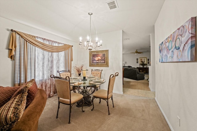 dining area with baseboards, ceiling fan with notable chandelier, visible vents, and light colored carpet