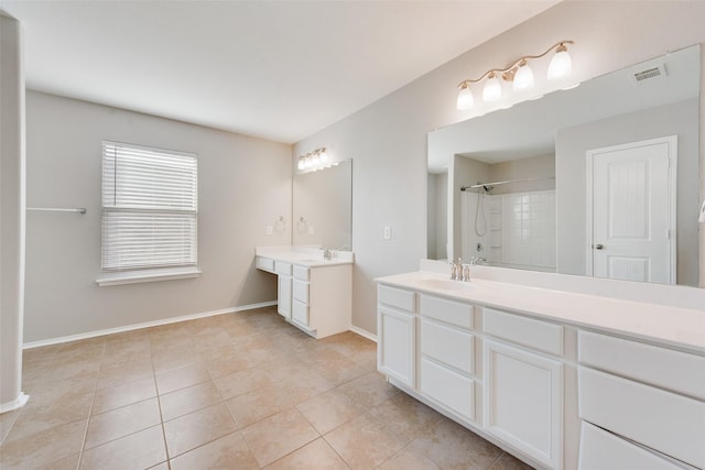 full bathroom featuring two vanities, a sink, baseboards, a shower, and tile patterned floors