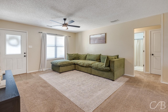 living room with carpet, visible vents, and a textured ceiling