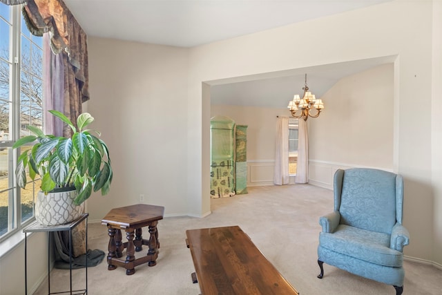 sitting room featuring a chandelier and carpet flooring