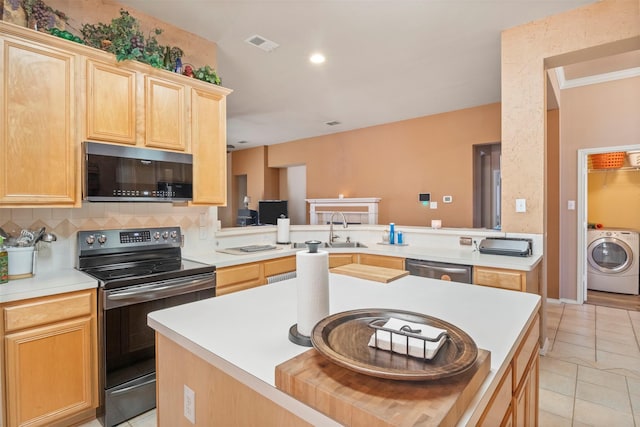 kitchen featuring stainless steel appliances, washer / clothes dryer, visible vents, light brown cabinets, and light tile patterned flooring