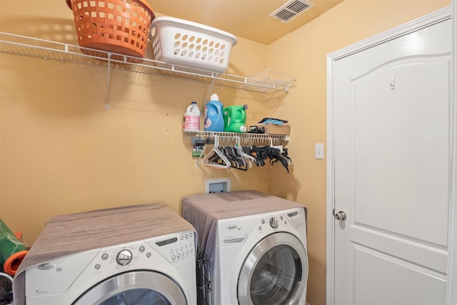 laundry room featuring laundry area, washing machine and dryer, and visible vents