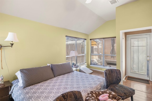 bedroom with lofted ceiling, wood-type flooring, and visible vents