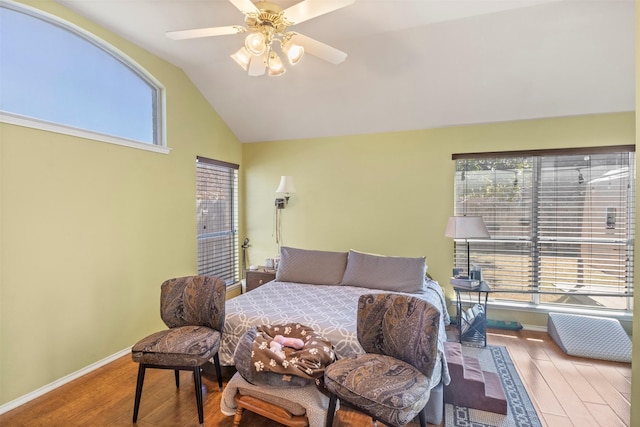 bedroom with vaulted ceiling, ceiling fan, wood finished floors, and baseboards