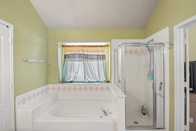 bathroom with a garden tub, vaulted ceiling, and a shower stall