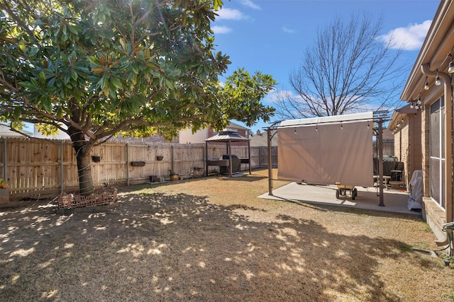 view of yard with a fenced backyard, a patio, and a gazebo