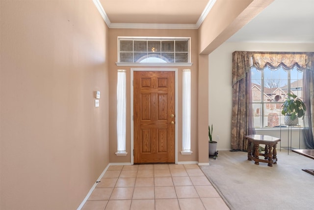 foyer entrance with ornamental molding, light colored carpet, light tile patterned flooring, and baseboards