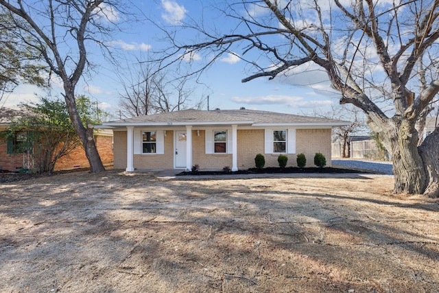 ranch-style home with fence and brick siding