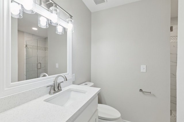 bathroom with toilet, a stall shower, visible vents, and vanity