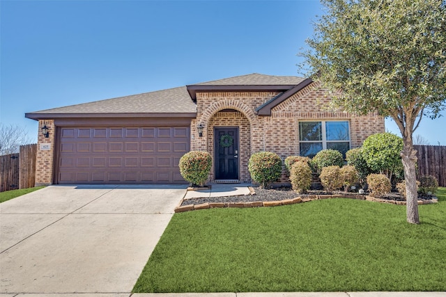 view of front facade featuring an attached garage, driveway, brick siding, and a front yard