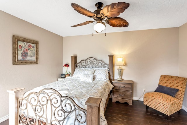 bedroom featuring ceiling fan, a textured ceiling, baseboards, and wood finished floors