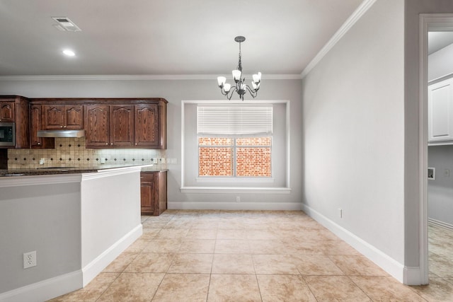 kitchen with visible vents, decorative backsplash, stainless steel microwave, crown molding, and under cabinet range hood