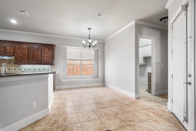 kitchen with ornamental molding, light tile patterned flooring, visible vents, and decorative backsplash