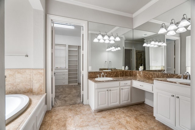 bathroom featuring a garden tub, double vanity, a sink, and crown molding