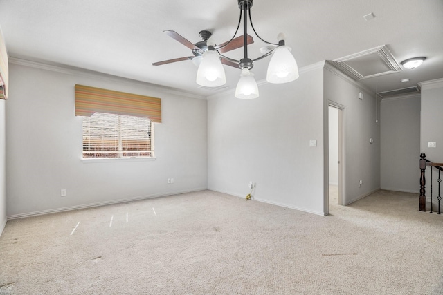 empty room with attic access, baseboards, a ceiling fan, ornamental molding, and carpet