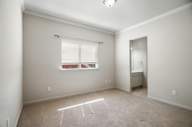 empty room with baseboards, carpet flooring, and crown molding