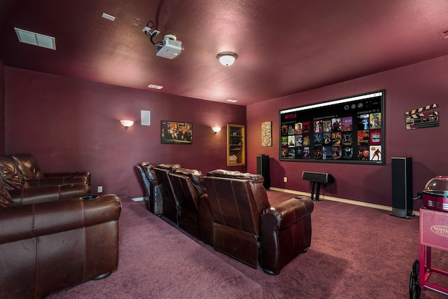 home theater room featuring carpet floors, visible vents, and baseboards