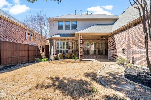 back of house featuring ceiling fan, a patio, brick siding, a shingled roof, and fence