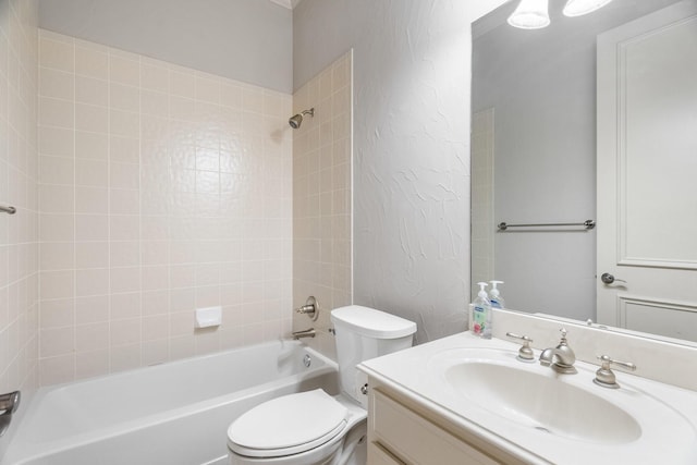 bathroom with a textured wall, tub / shower combination, vanity, and toilet