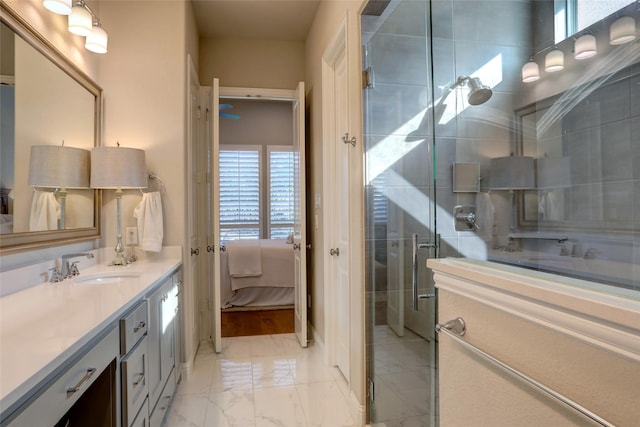 bathroom with ensuite bathroom, marble finish floor, a shower stall, and vanity