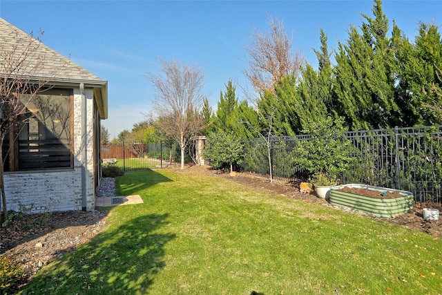 view of yard featuring a fenced backyard and a garden