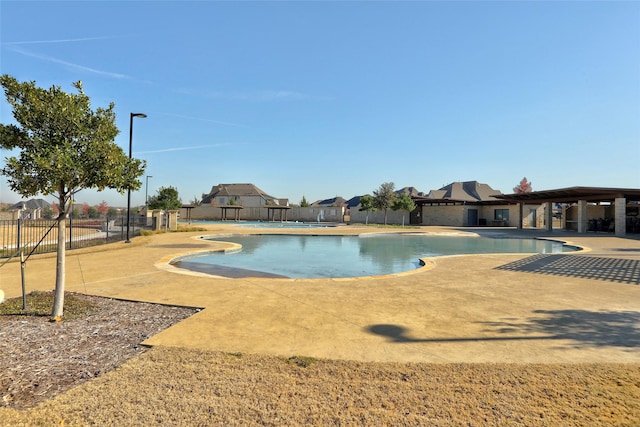 view of swimming pool featuring a fenced in pool, fence, and a patio