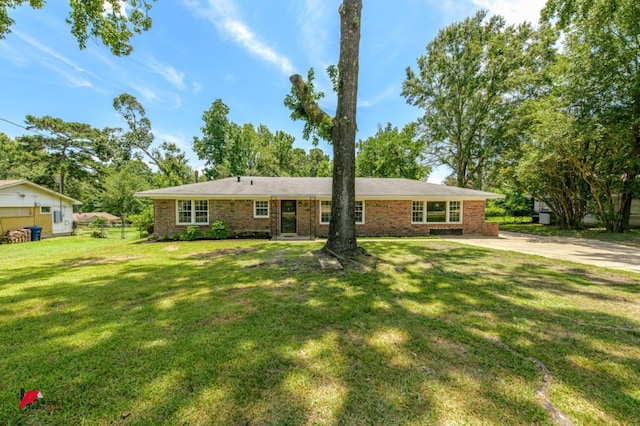 ranch-style home featuring brick siding and a front yard