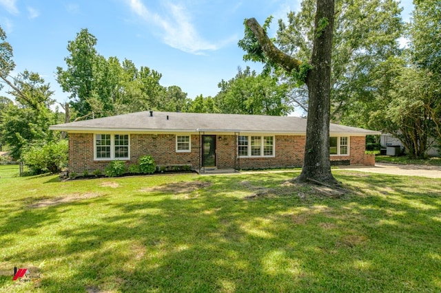 single story home featuring a front lawn and brick siding