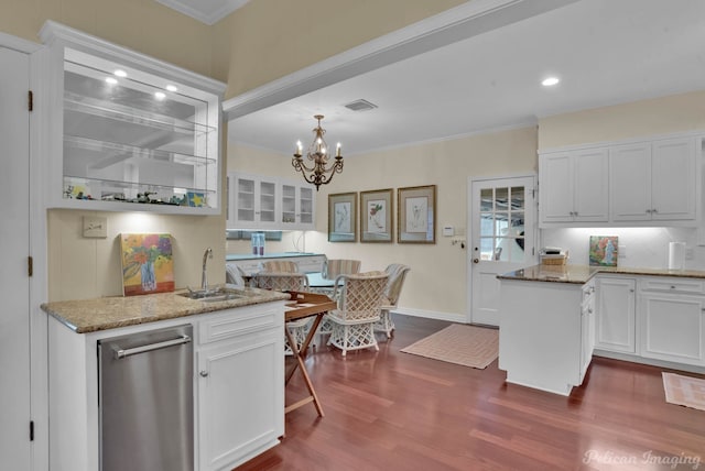 kitchen with white cabinetry, visible vents, dark wood-style flooring, and a sink