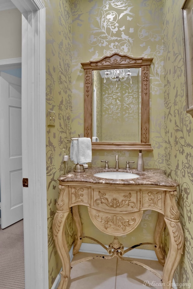 bathroom with vanity and wallpapered walls