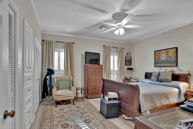 bedroom with ornamental molding, multiple windows, and visible vents