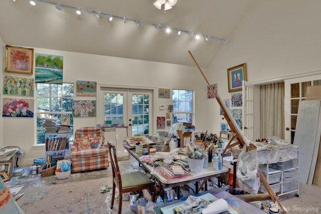 dining area with high vaulted ceiling, french doors, plenty of natural light, and track lighting